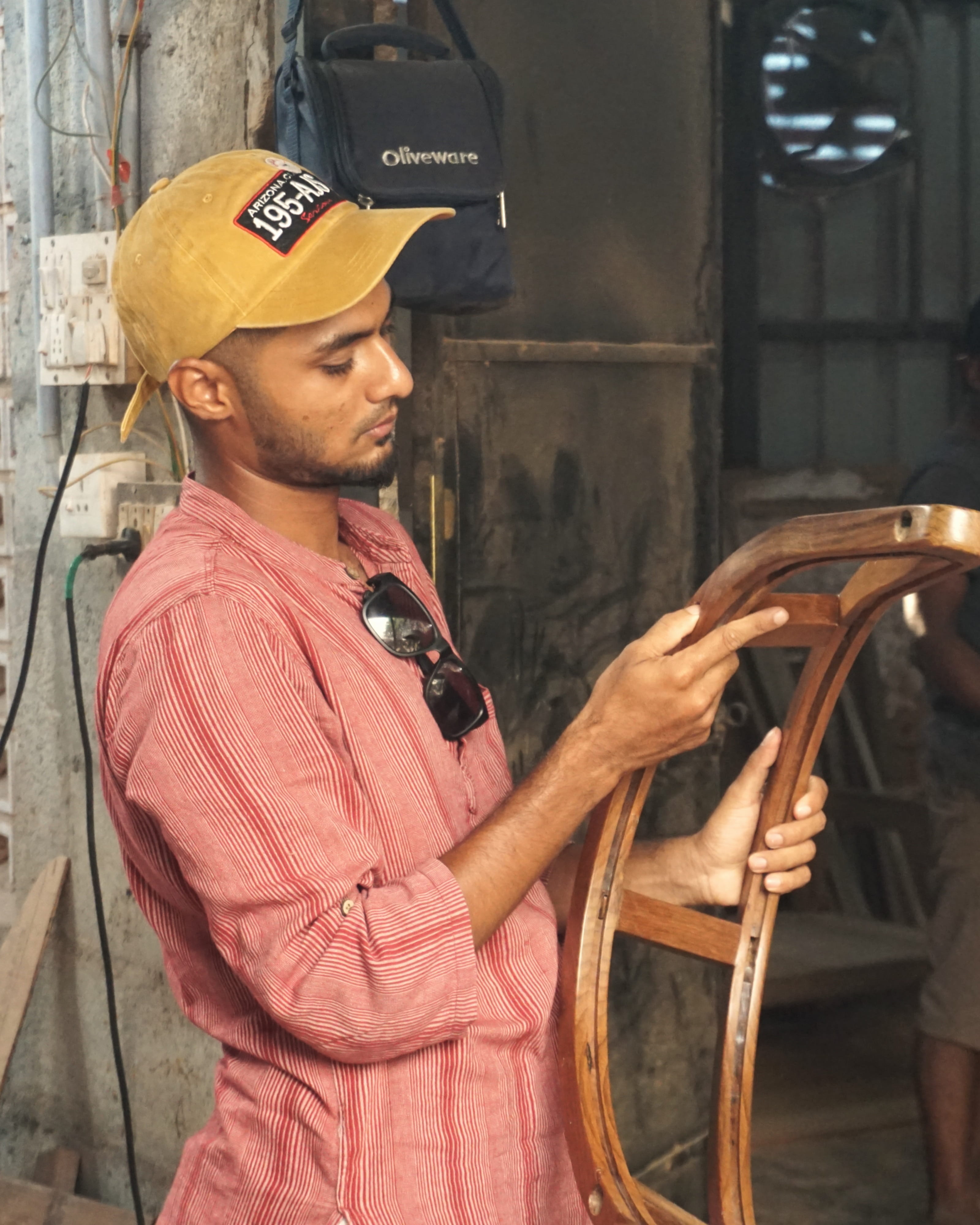 Founder of East Coast Modern showcasing handcrafted wooden furniture