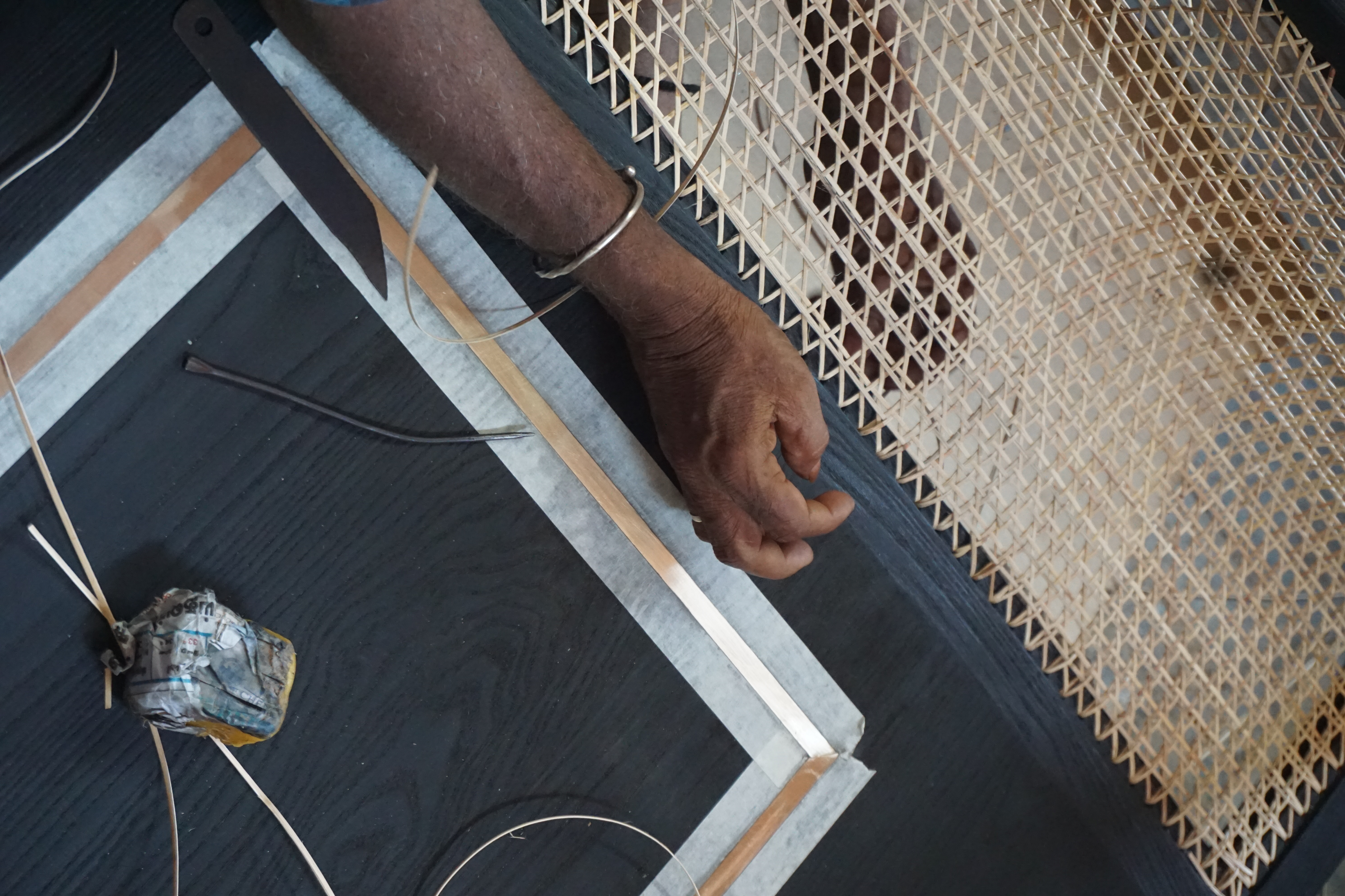 Hand-weaving rattan furniture at East Coast Modern - traditional Pondicherry craftsmanship